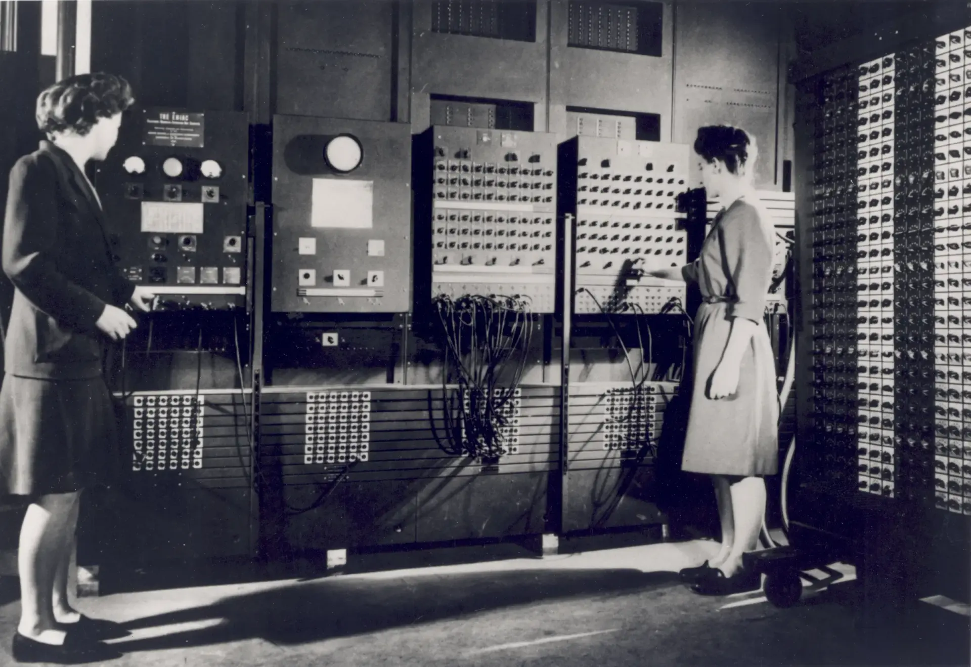 Betty Jennings and Frances Bilas working at the ENIAC control panels.