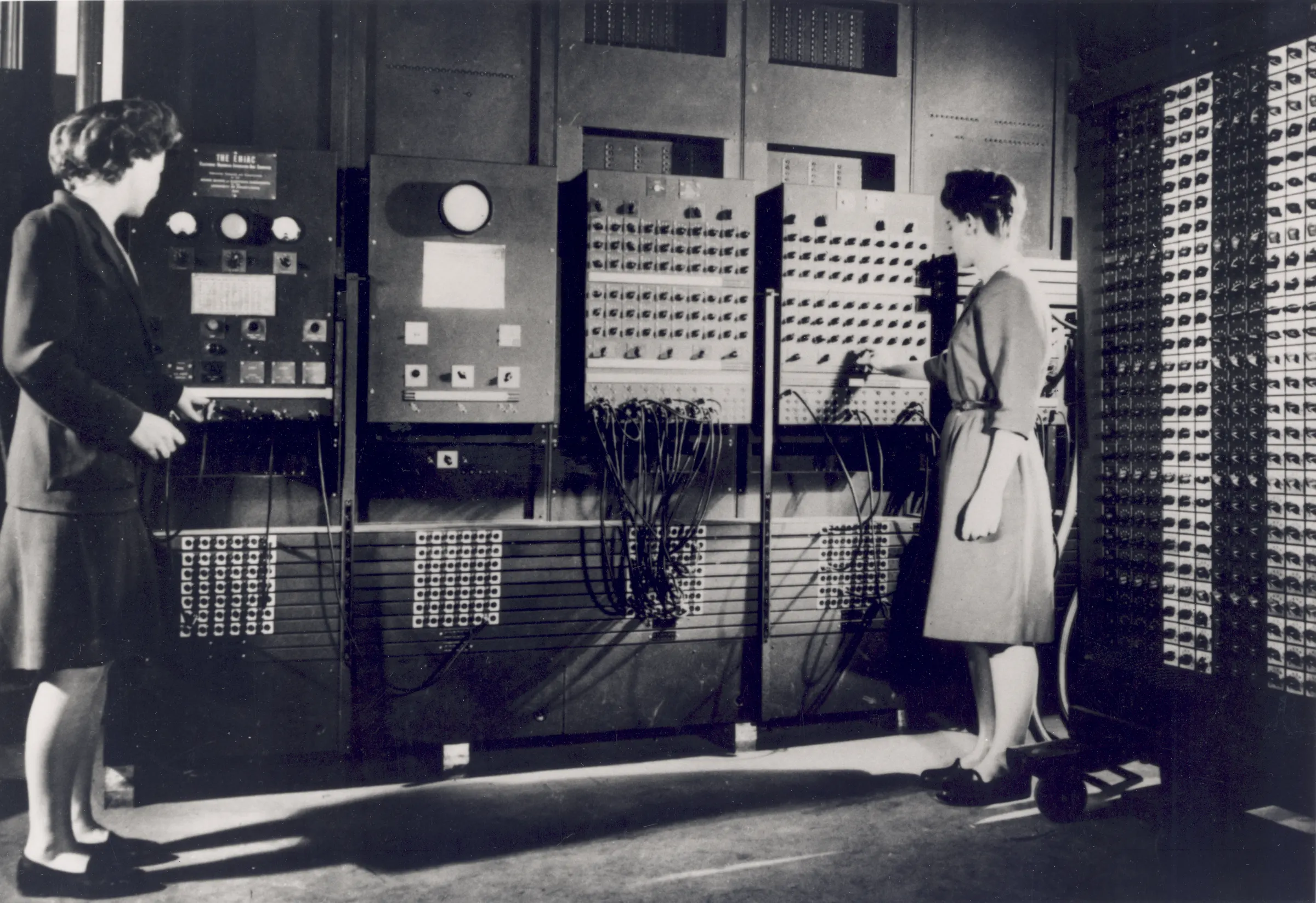Betty Jennings and Frances Bilas working at the ENIAC control panels.