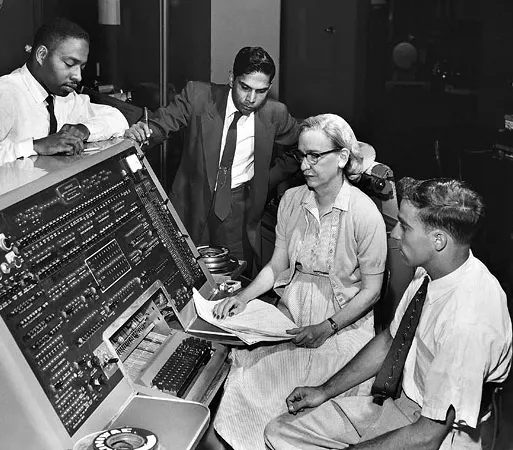 Grace Hopper and colleagues at a UNIVAC keyboard.